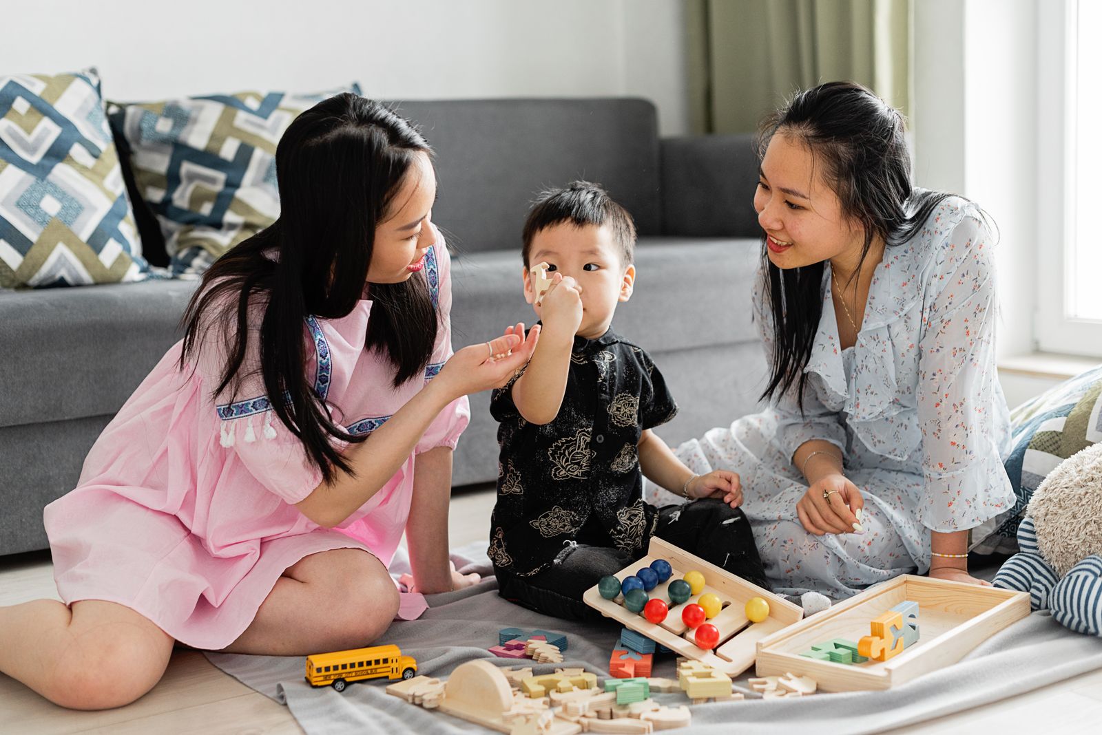 Family sharing a warm play moment with wooden educational toys