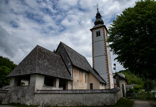 Free Historic St. John the Baptist Church with a scenic backdrop in Slovenia. Stock Photo