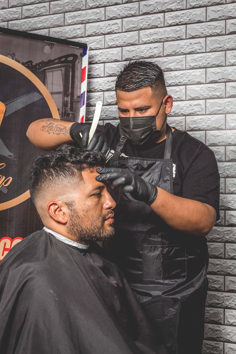 A Barber Wearing Black Latex Gloves