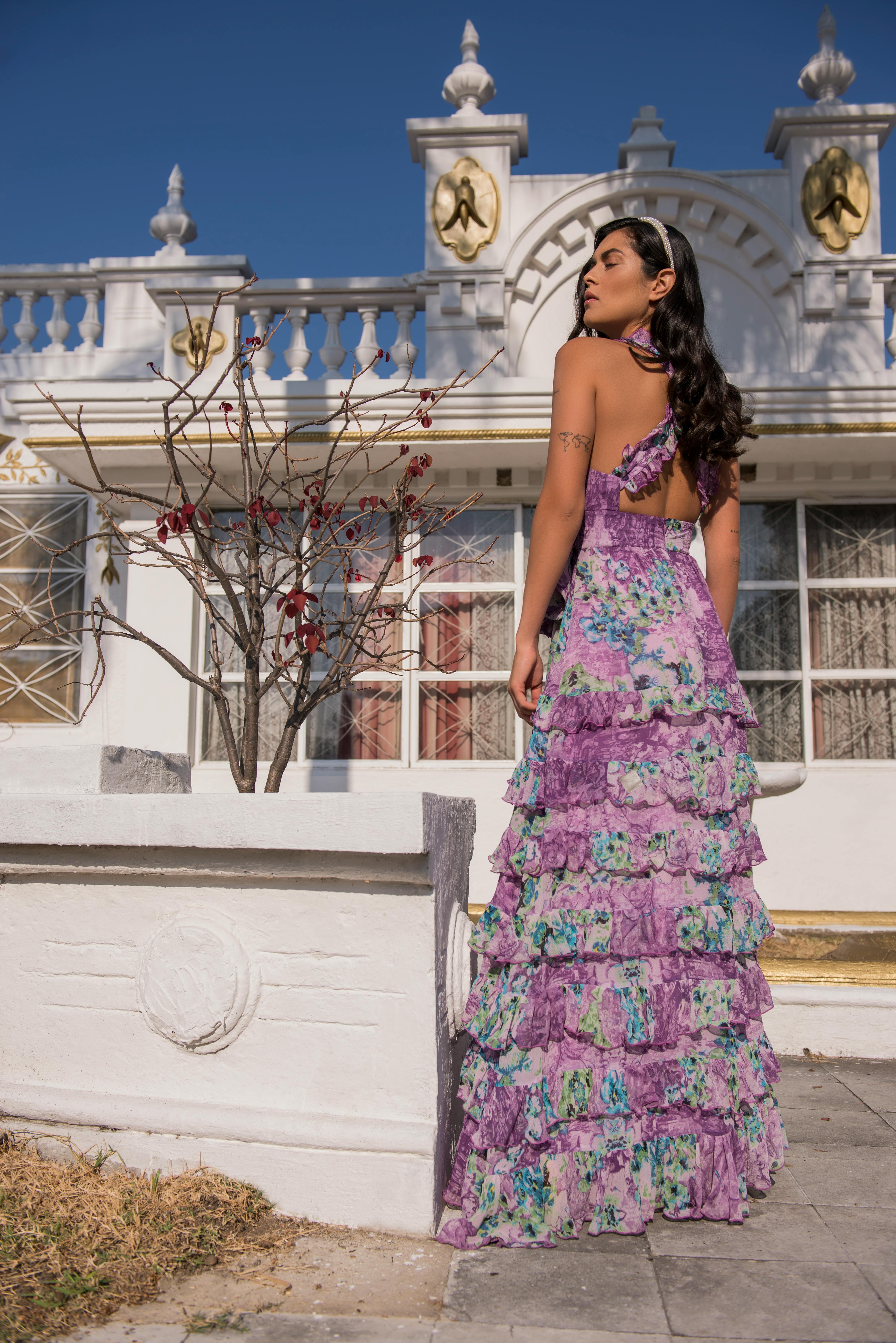 woman wearing a long purple floral print dress