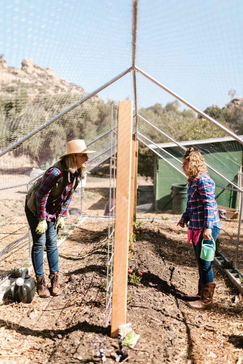 A mother and daughter gardening together in the greenhouse