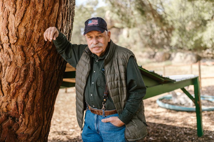 Farmer Leaning Against Tree