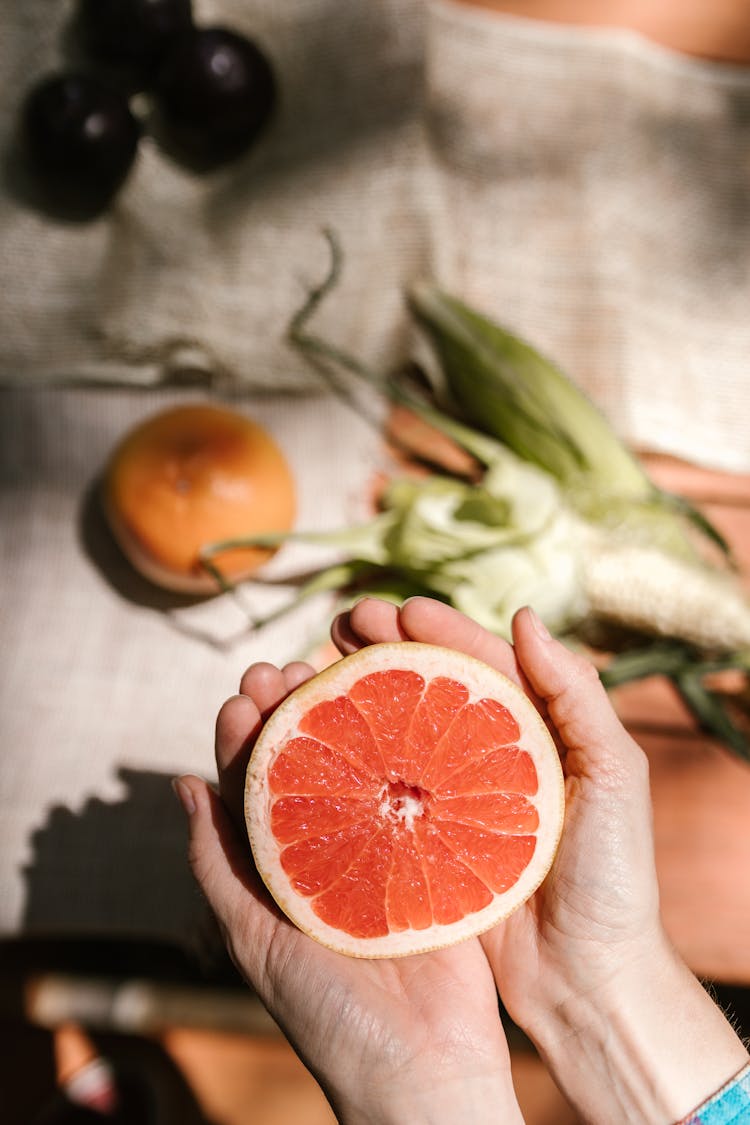 Person Holding A Citrus Fruit