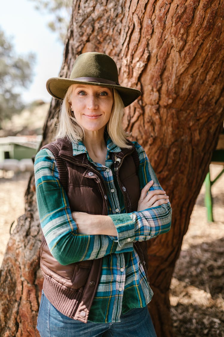 Smiling Farmer Standing By Tree