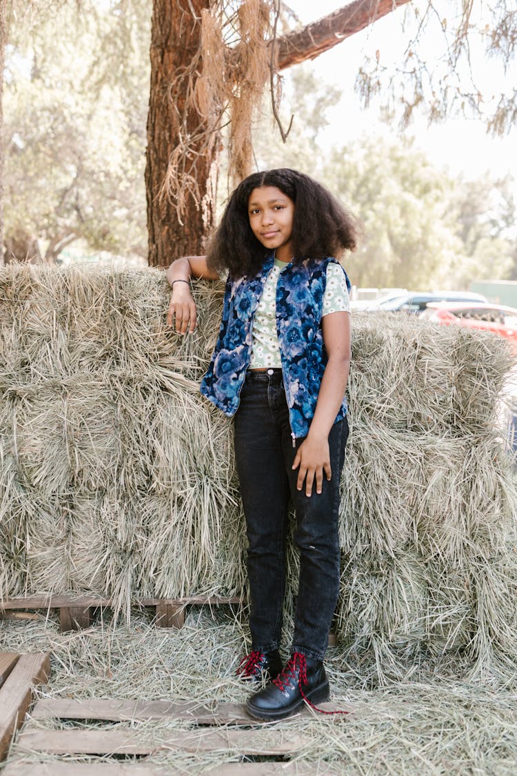 A Girl Leaning On A Haystack