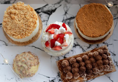 Set of delicious deserts on marble table