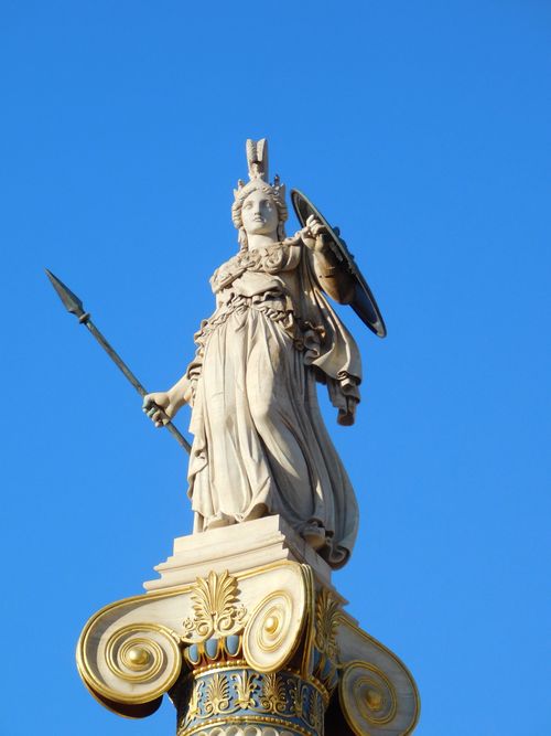 Free A stunning statue on a pillar against a clear blue sky, exemplifying classical art. Stock Photo