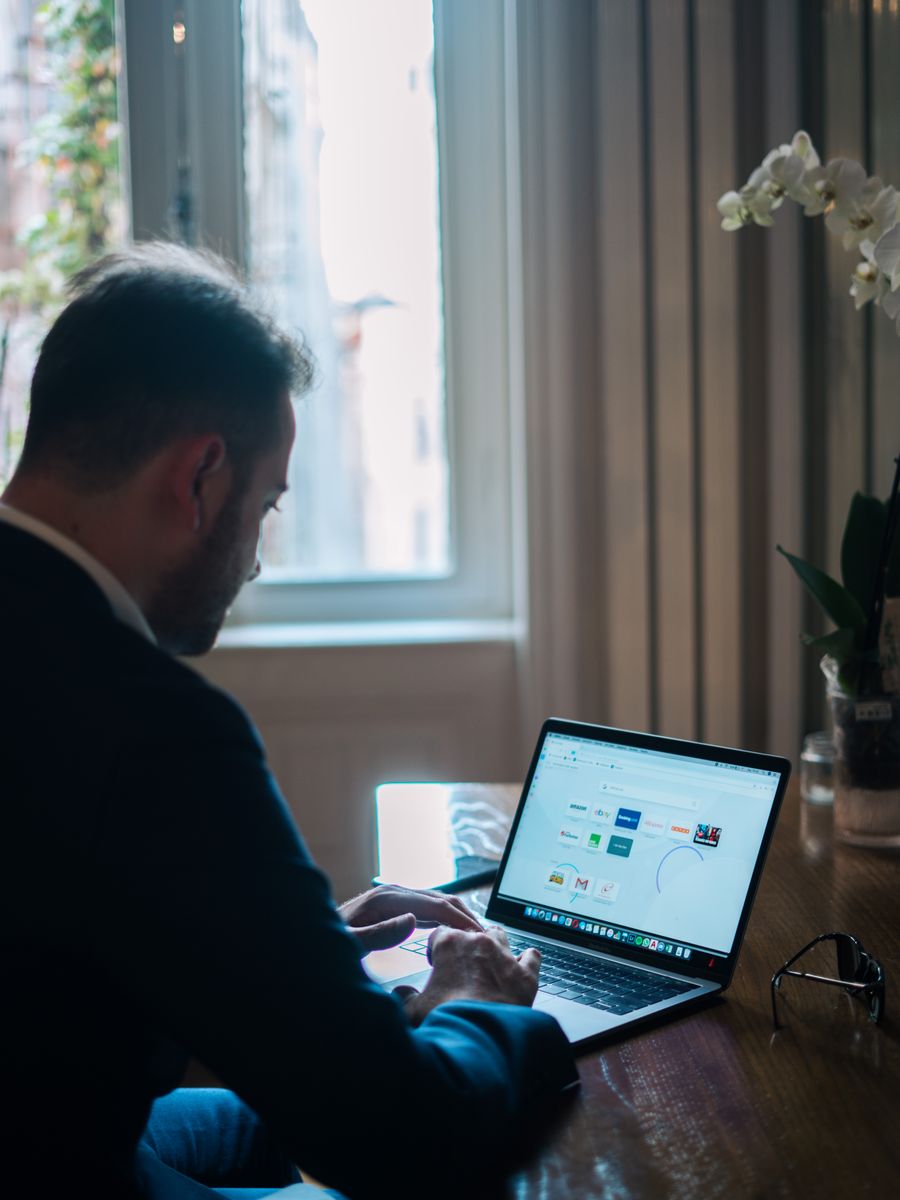 Man concentrating on a laptop at a table