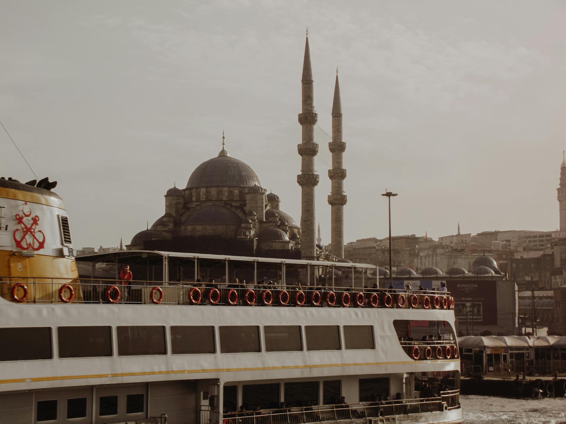 Istanbul skyline featuring a mosque and a passenger ship on the canal.
