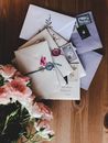 Pink roses and letters on wooden surface
