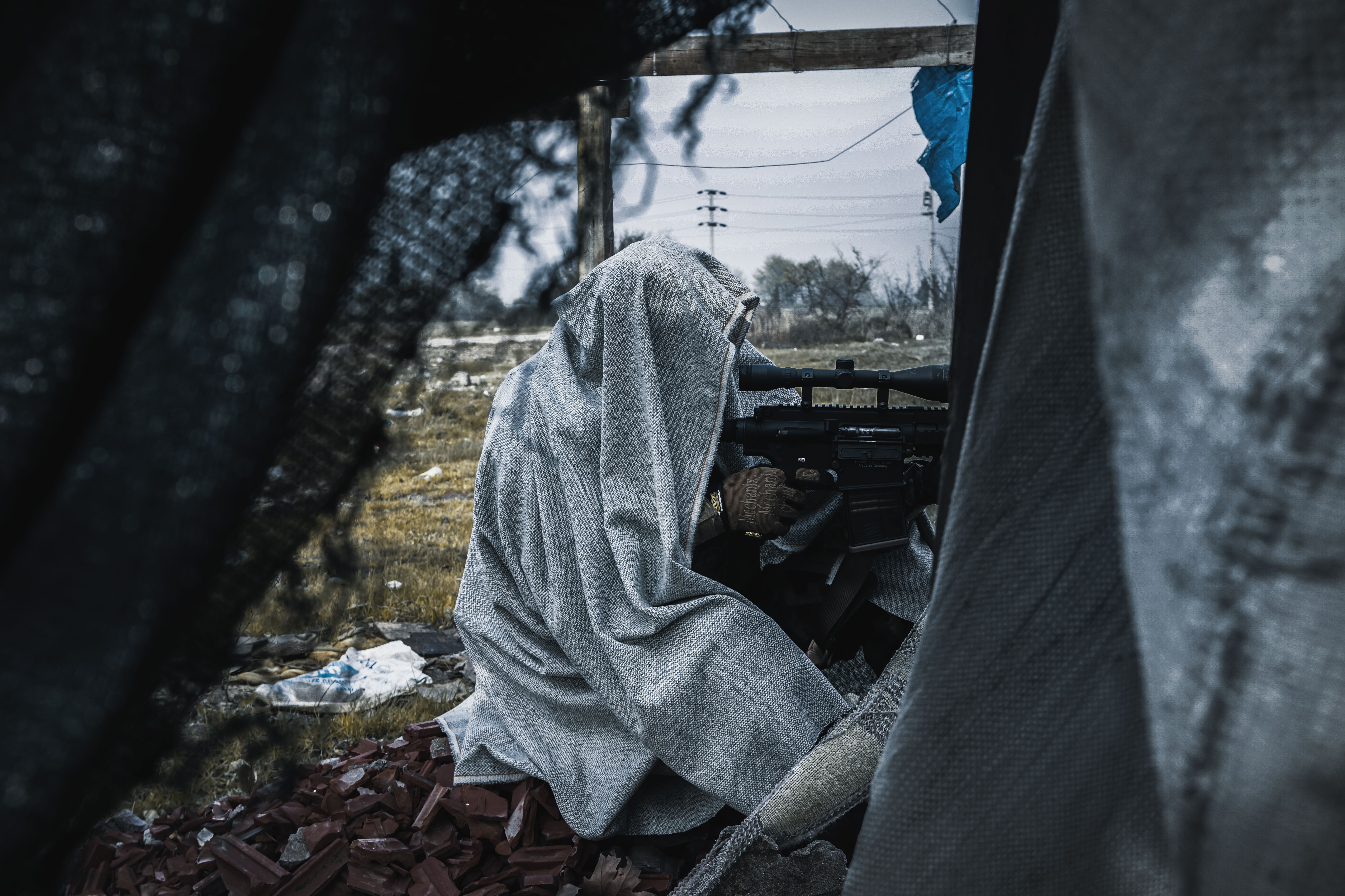 A Navy SEAL sniper providing overwatch from a concealed position