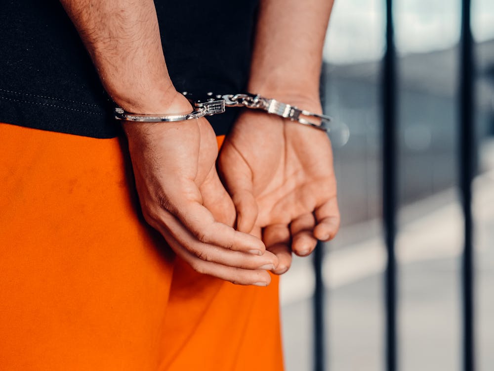 A defendant in handcuffs before paying bail 