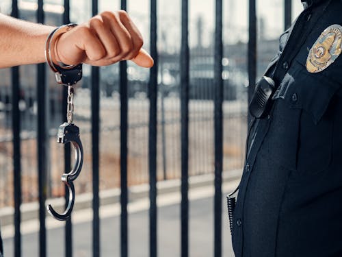 Free A Person's Hand in Handcuff Stock Photo