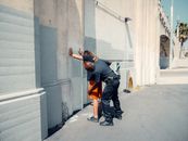 An Officer Frisking a Man