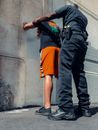 An Officer Frisking a Man