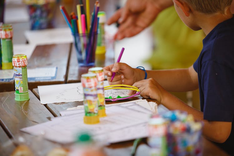 A Kid Drawing On White Paper