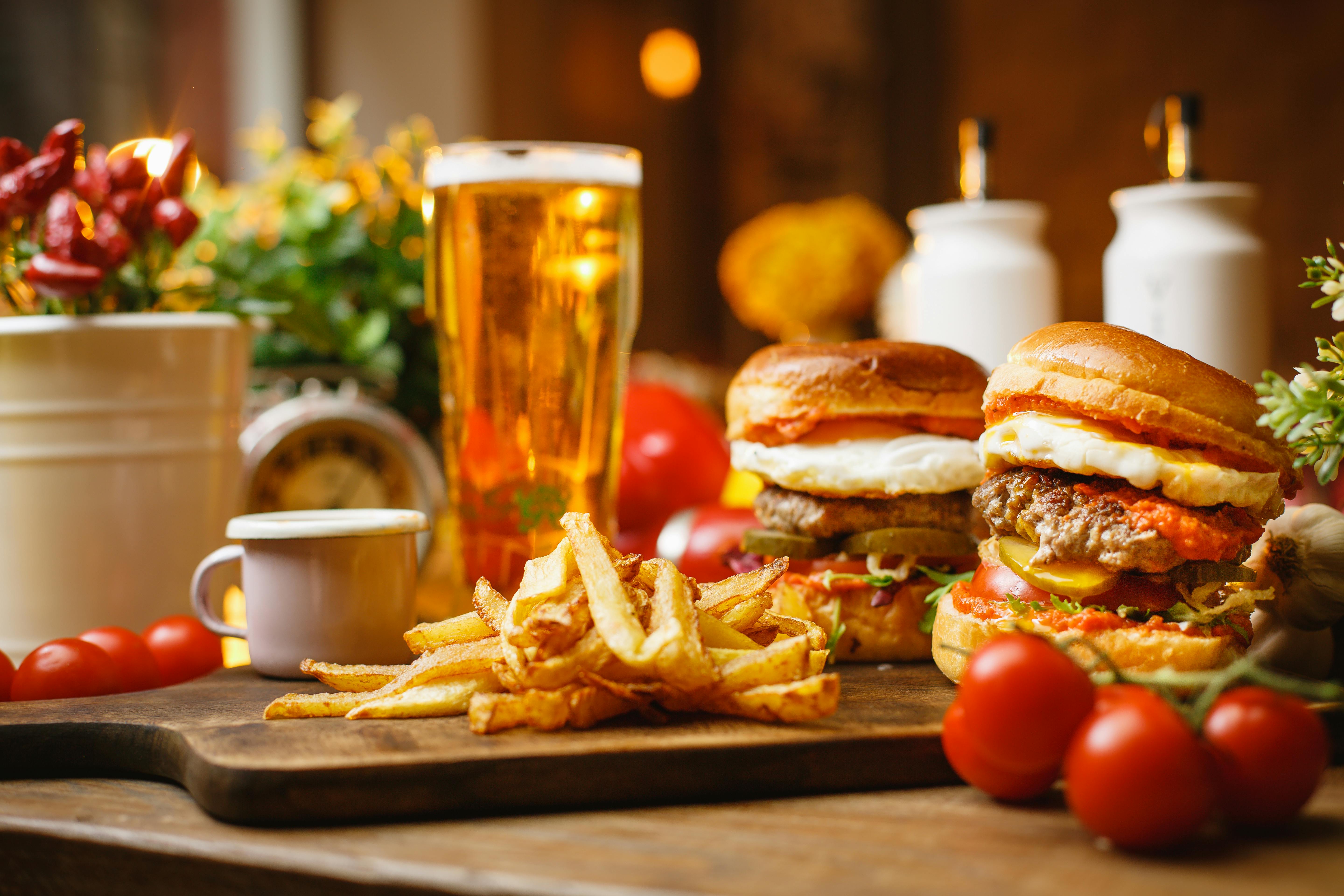 gourmet burger next to a craft beer - restaurants sports bar