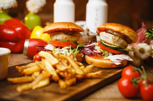Plant-based burgers and fries on a board — photo by Andrei Marina on Pexels
