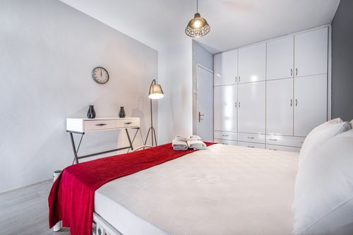 Free Stylish modern bedroom in Antalya featuring cozy decor and bright white furnishings. Stock Photo