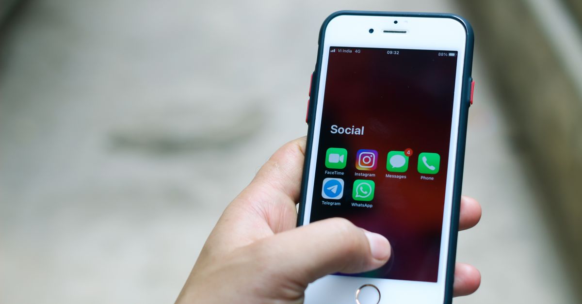 A person reading messages on a smartphone — two-way messaging keeps the whole job conversation in one written thread