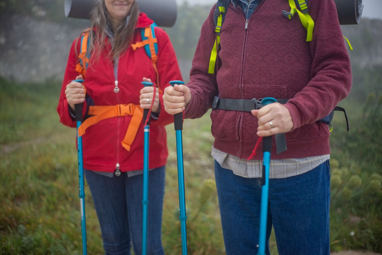 Couple hiking on a mountain trail with scenic background