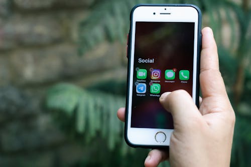 Person Holding White Iphone 6 With Black Case