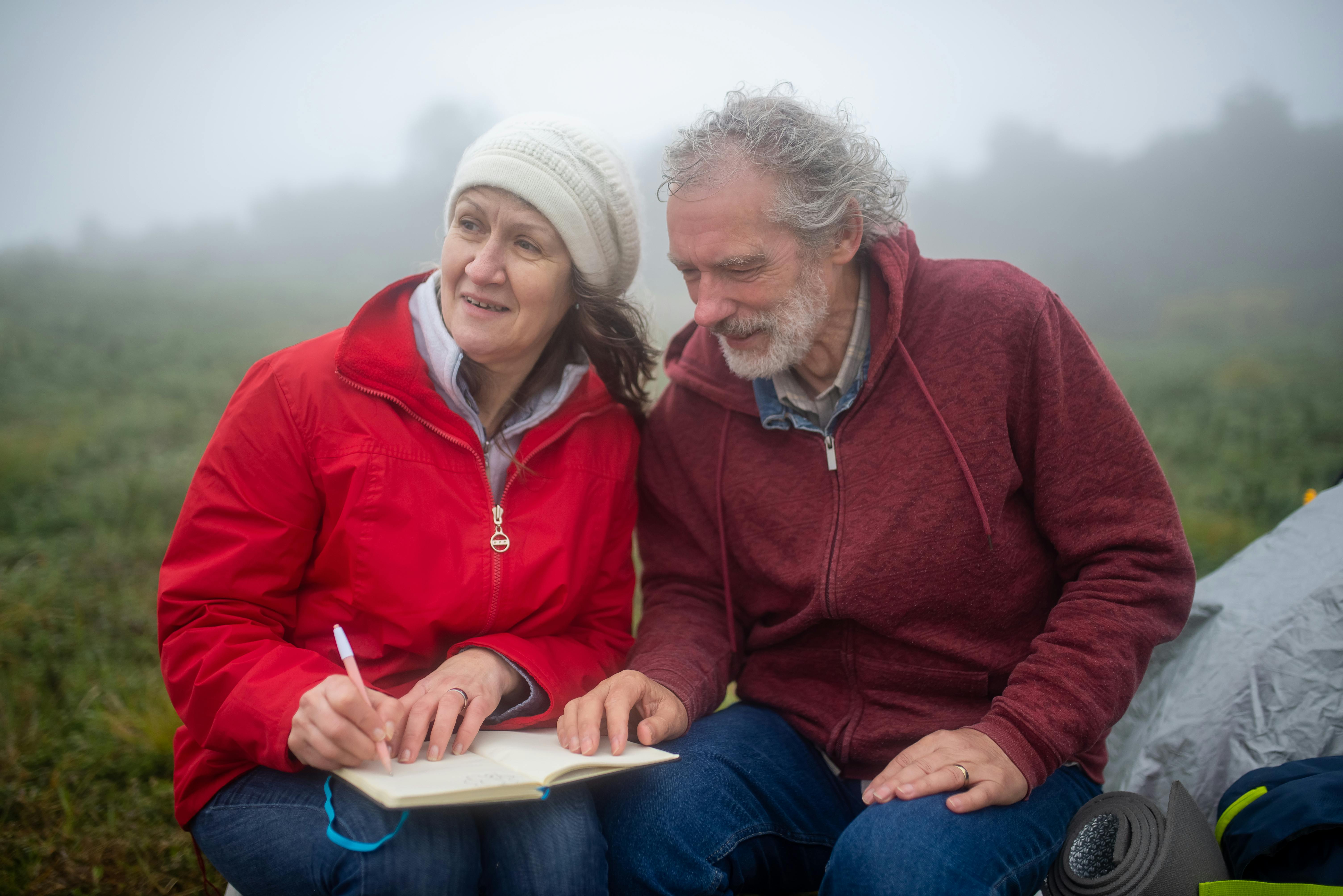 Couple writing in a travel journal together