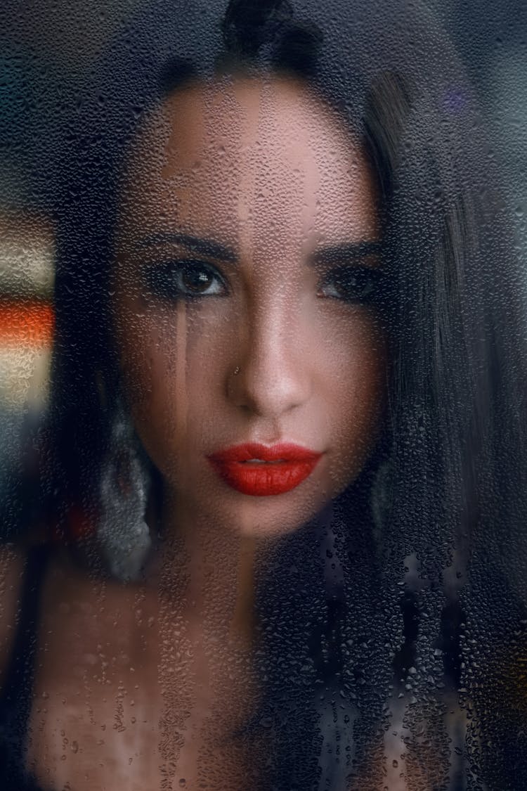 Sensual Woman Looking Through Fogged Window