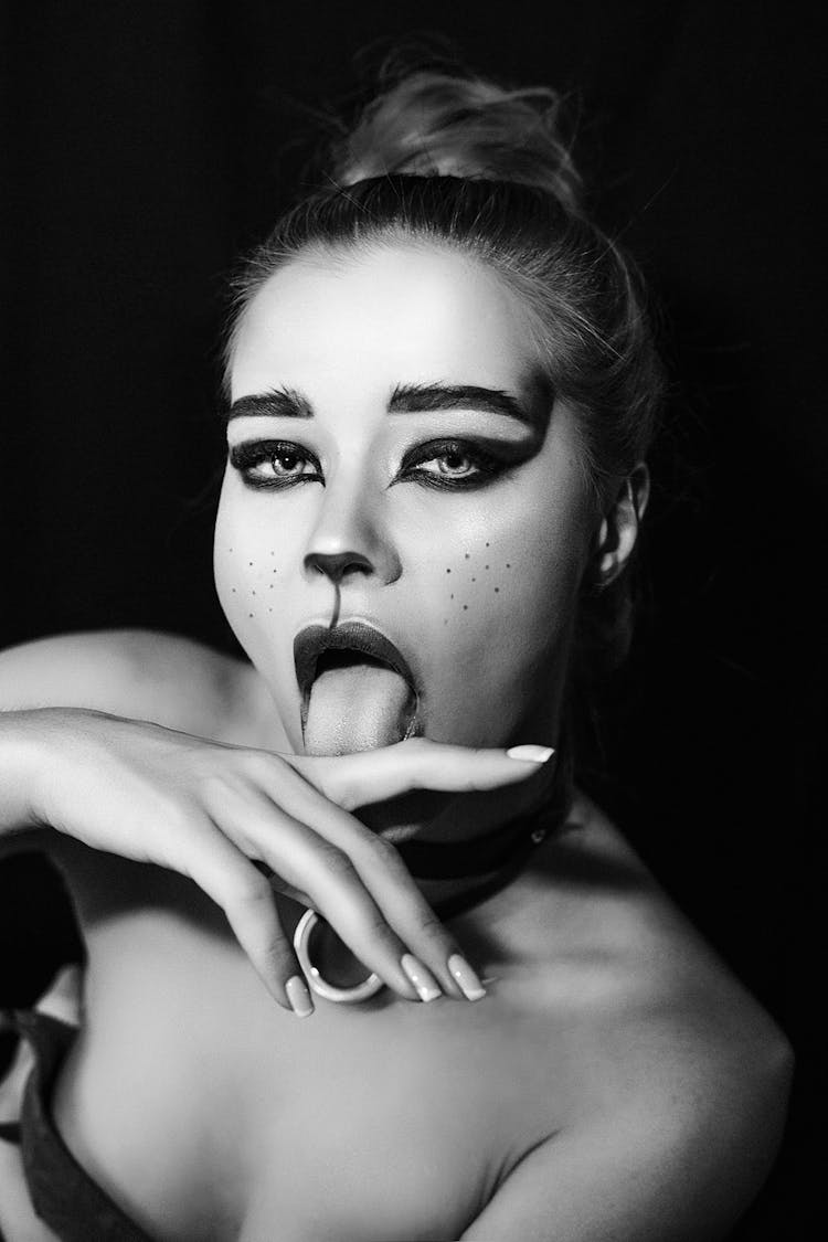 Woman With Animal Makeup Licking Finger