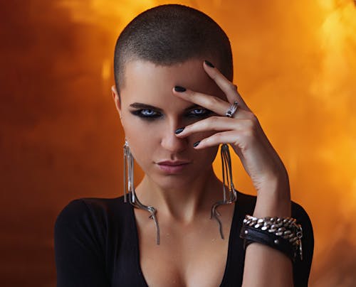 Free Stylish model with short hair staring and touching face Stock Photo