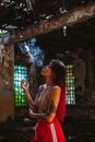 Eccentric woman fuming cigarette in disused building