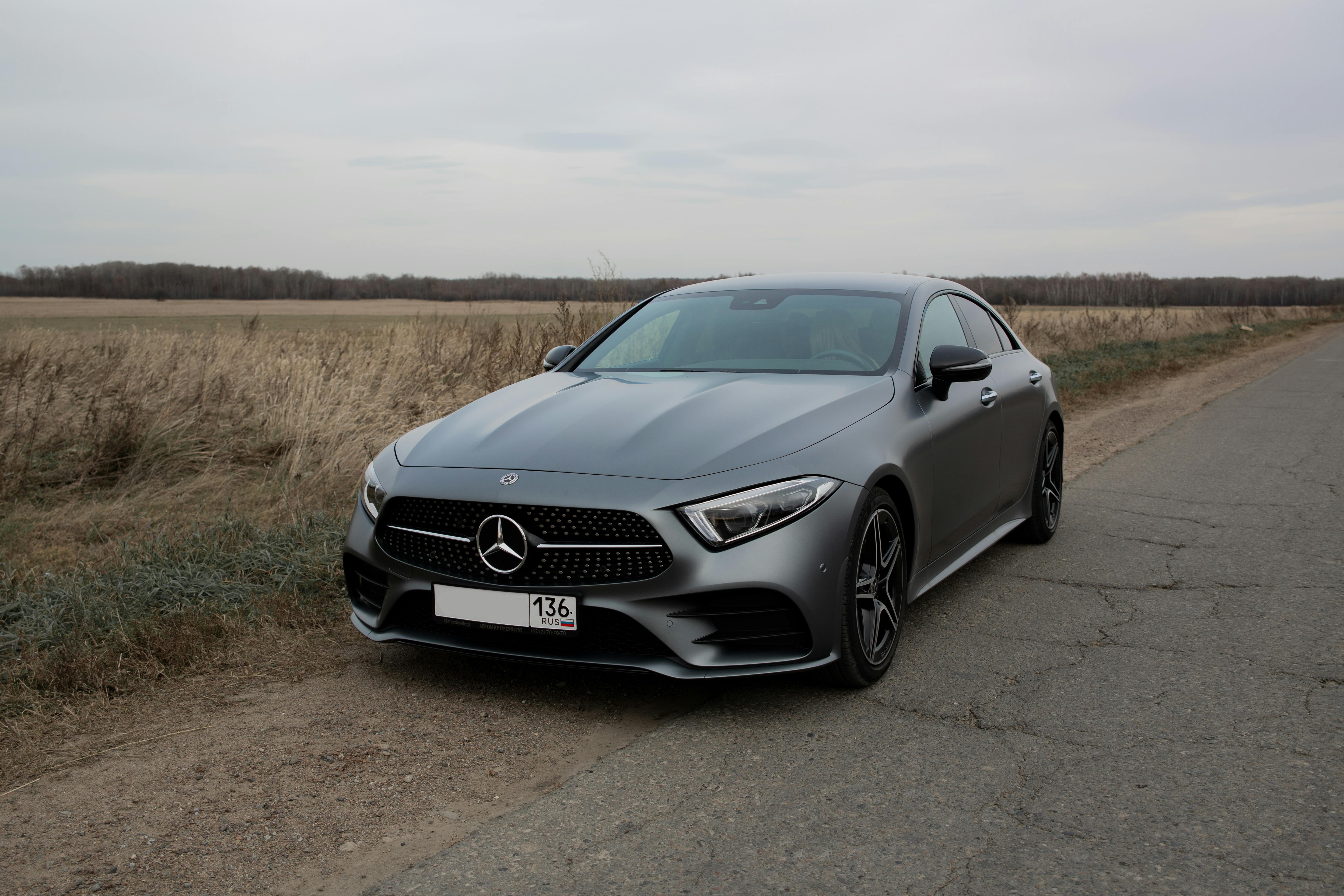 luxury glossy gray polished car parked on roadside in countryside