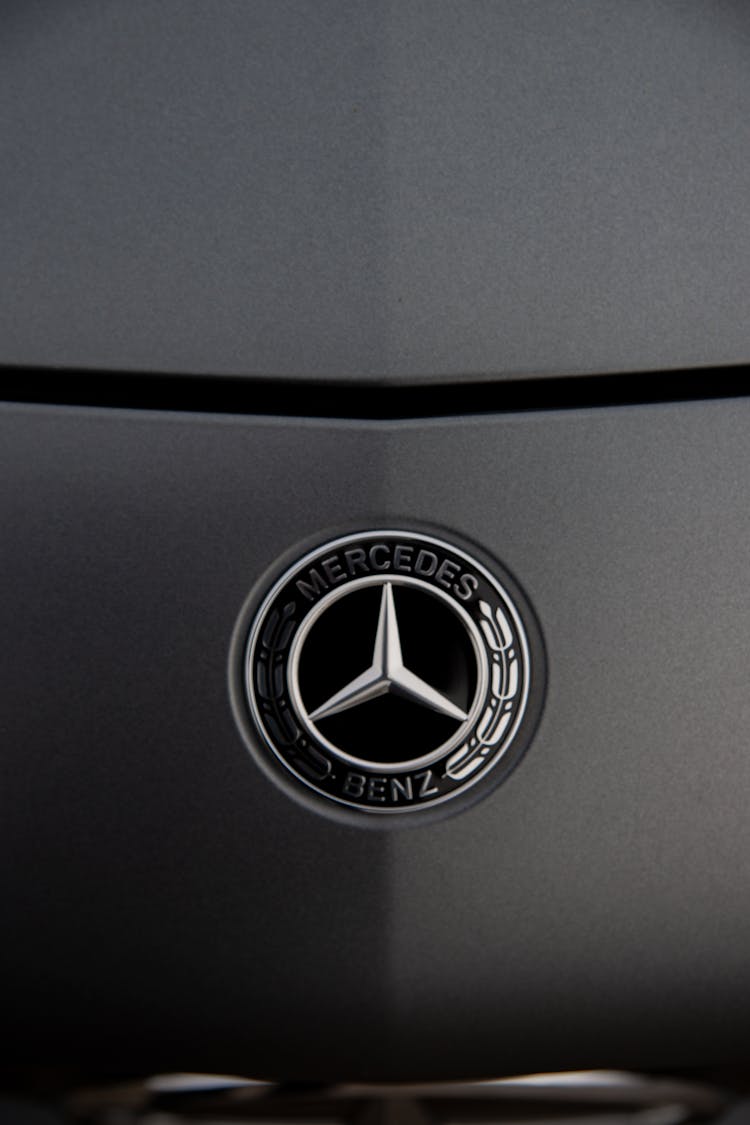 Logo Of Luxury Auto Placed On Dark Grey Car Hood