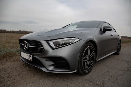 Free Luxury silver automobile with switched off headlight and tinted glass parked on roadside in rural area Stock Photo