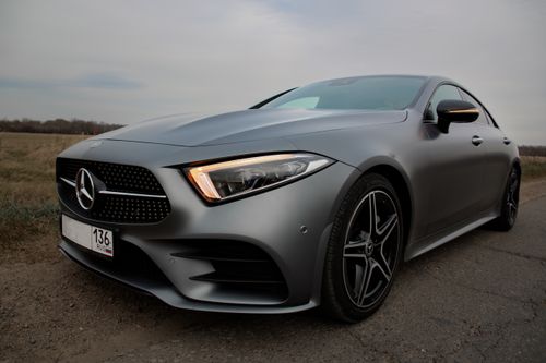 Free Modern shiny expensive gray auto with switched on headlights parked on roadside in countryside Stock Photo