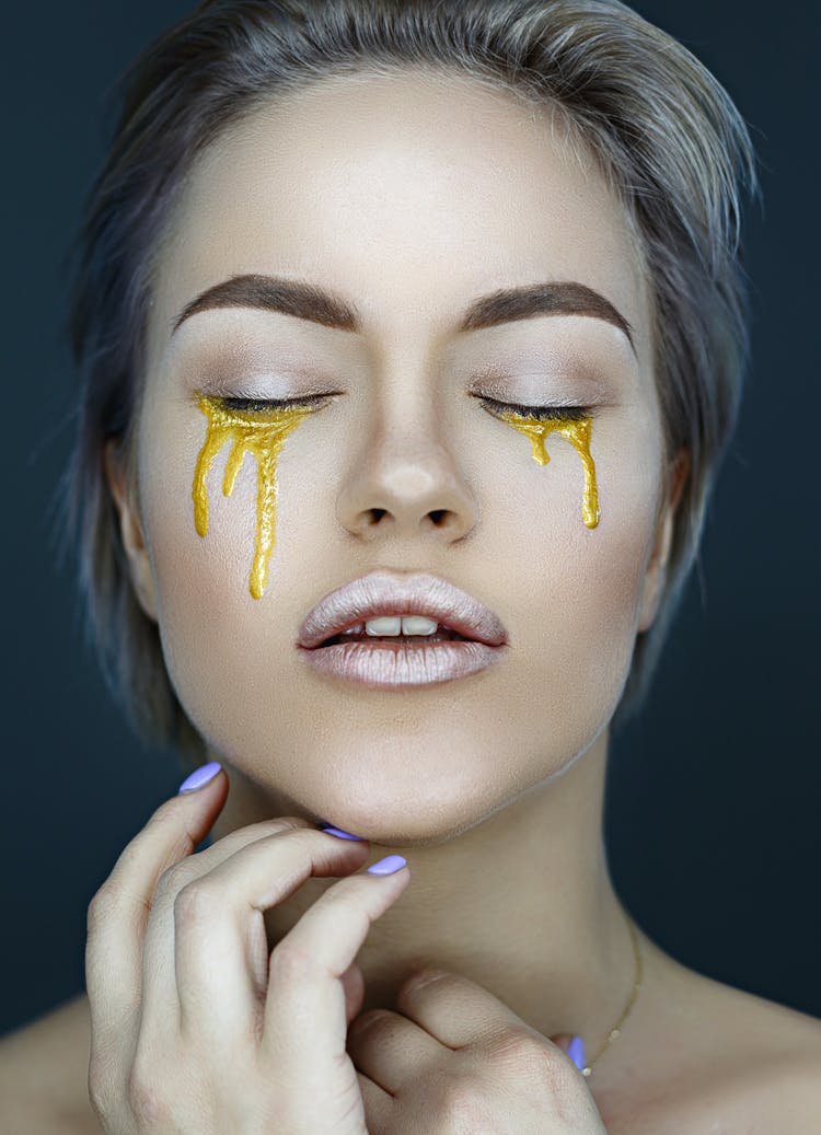 Stylish Woman With Gold Artistic Makeup Under Eyes