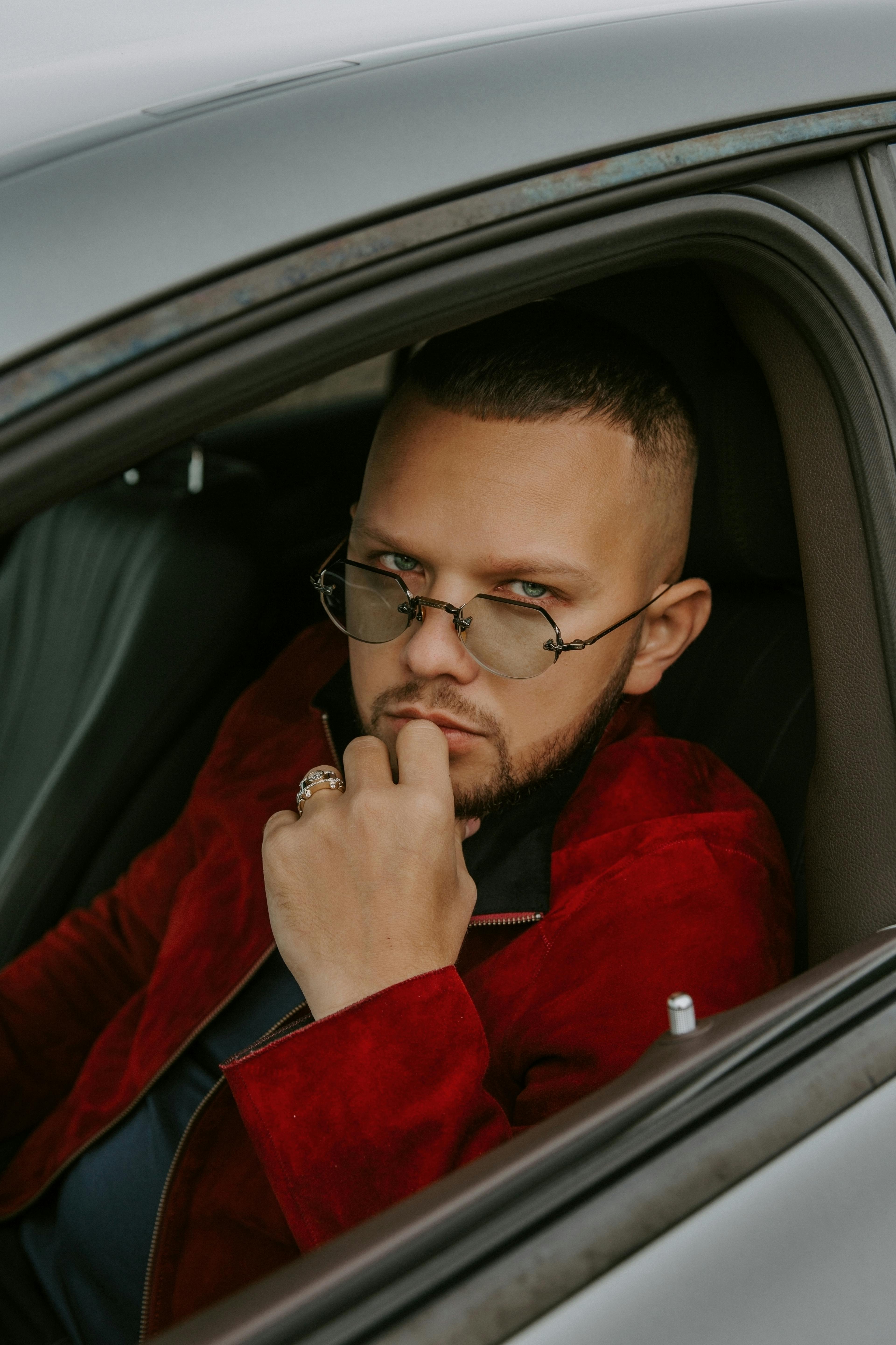 trendy young man sitting in car