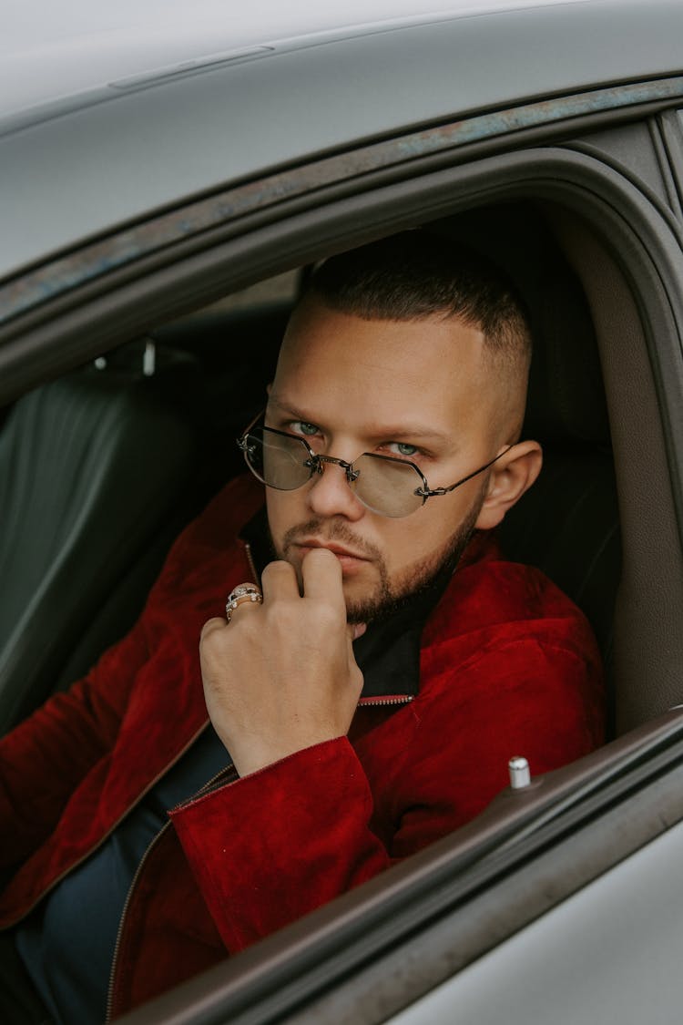 Trendy Young Man Sitting In Car