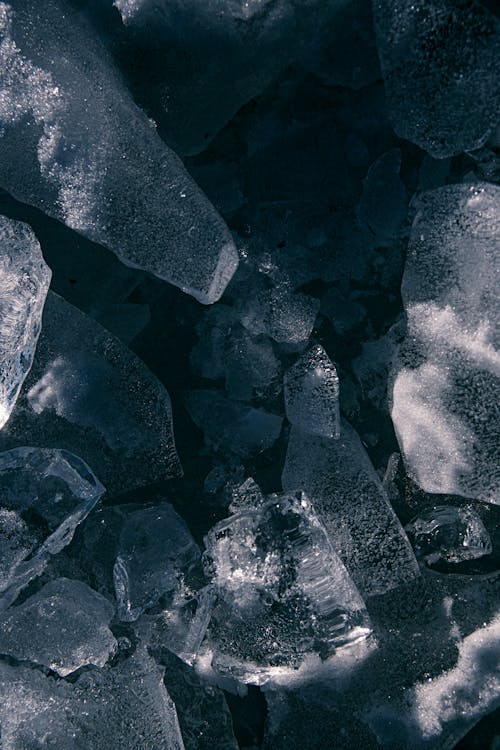 Abstract uneven surface of dark gray ice pieces