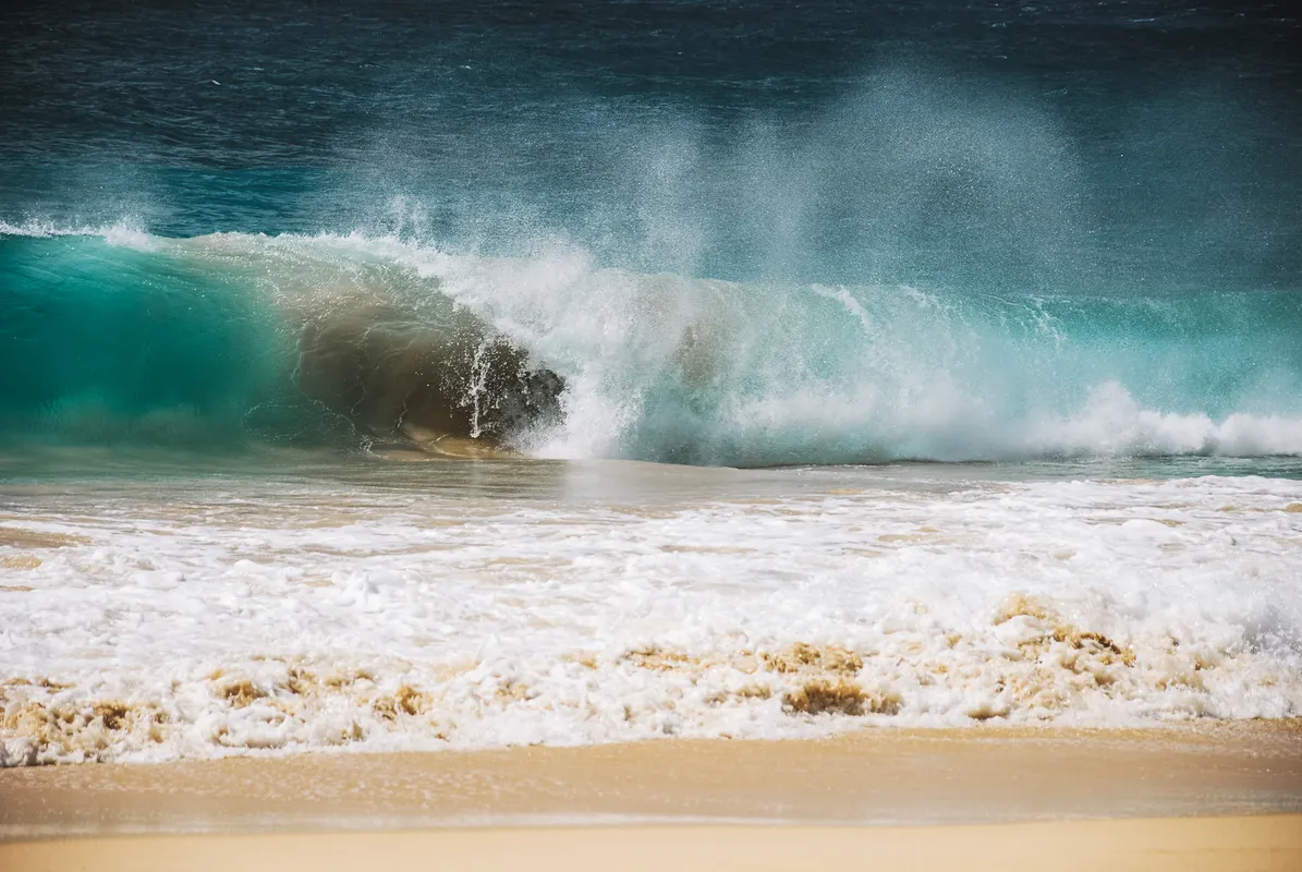 Waves crashing on a Hawaii beach at golden hour, North Shore Oahu
