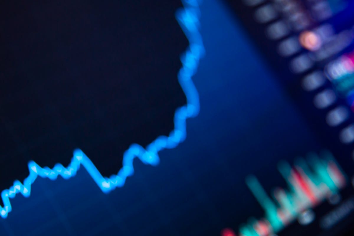 Person analyzing charts with a laptop, symbolizing tokenized financial assets