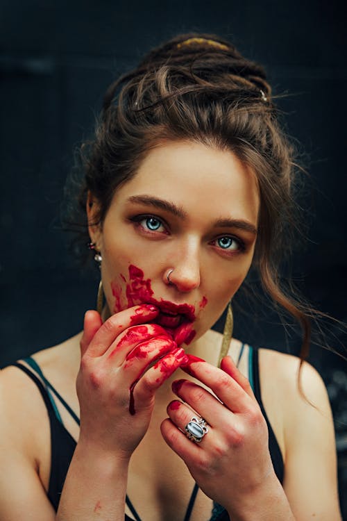 Free Young female with blood on hands and face Stock Photo