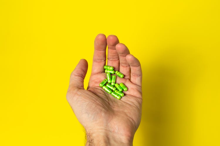 Man Holding Pills In Hand