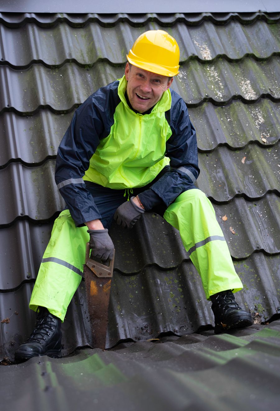 Roofing technician performing a detailed roof inspection