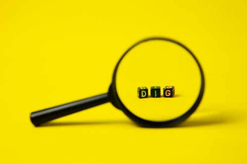 Magnifying glass placed on yellow background