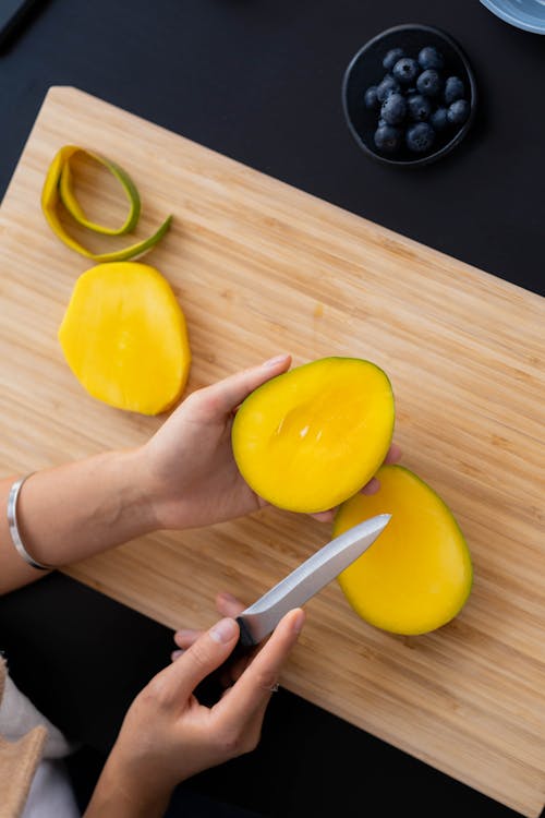 Person Holding Yellow Round Fruit