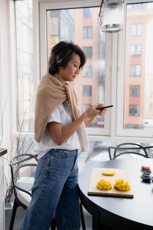 Woman in White Shirt Taking Photos of Food