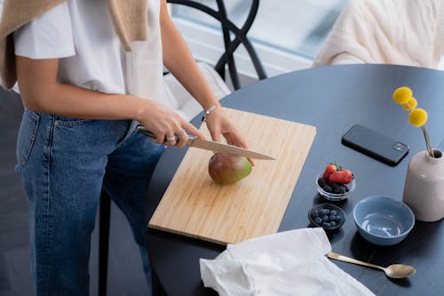 Woman Slicing a Mango