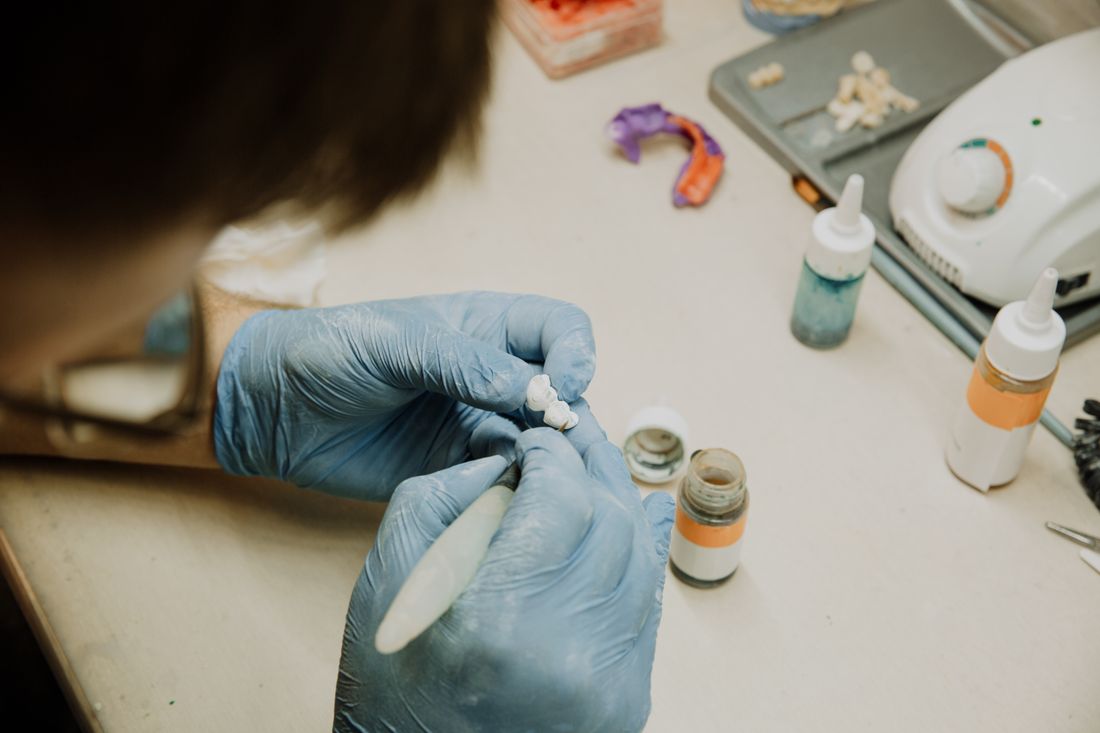 Dental technician working on a dental prosthetic