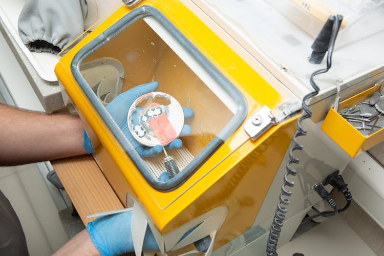 Crop Unrecognizable Man Working On Dental Equipment